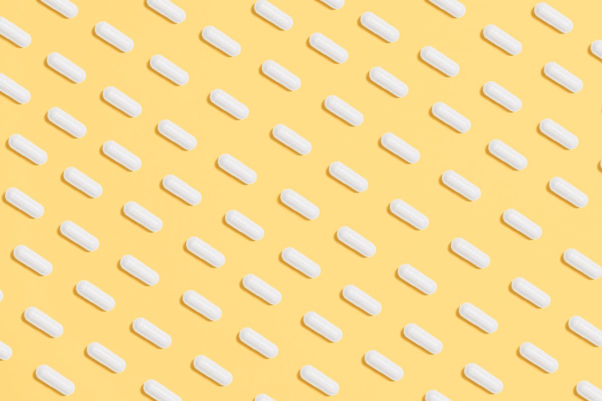 White pills on a yellow background