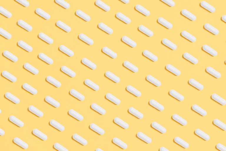 White pills on a yellow background